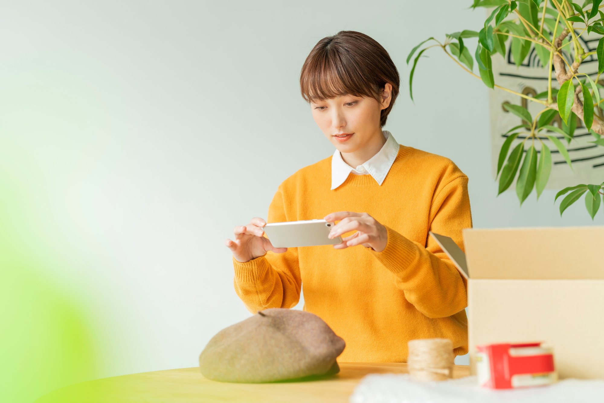 スマートフォンで商品を撮影し投稿準備をする様子